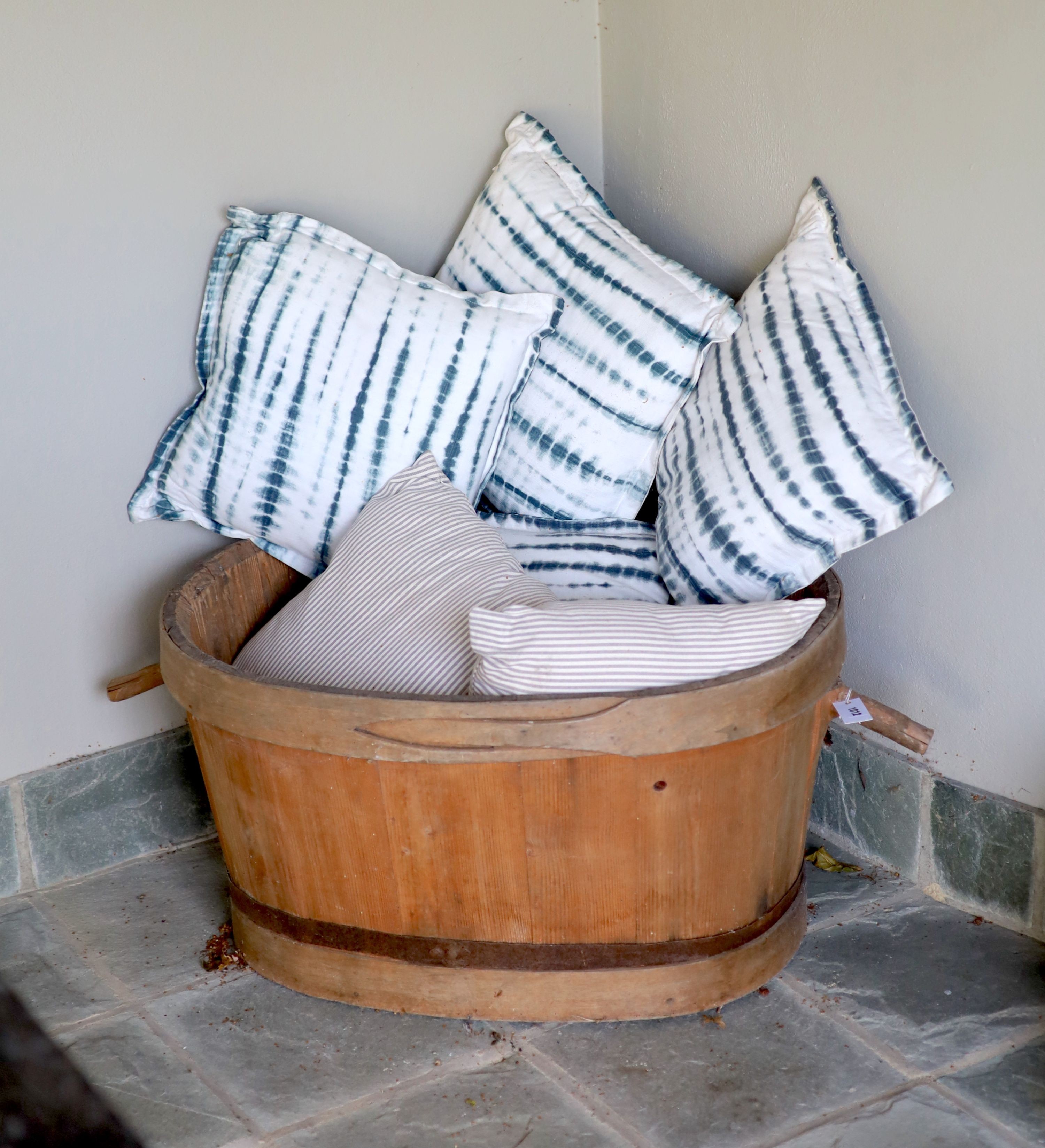 A French coopered pine grape bin, width over handles 97cm, and six assorted cushions